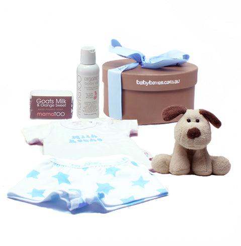 Baby gift box for a baby boy. Included in the gift box is a soft puppy toy for baby, a cute tshirt either plain or with a slogan print and cute little boxershorts with blue stars on them. Mama TOO pampering products are also included for mum too, an organic body massage oil for both new baby and mum and also a Goats Milk soap for mum.  This baby gift is beautifully presented in a keepsake round box, tied up with quality ribbon and beautifully presented.